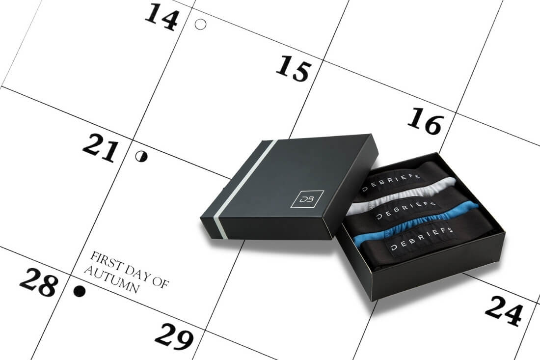 Underwear subscription box laying on top of a calendar - Debriefs mens underwear subscription