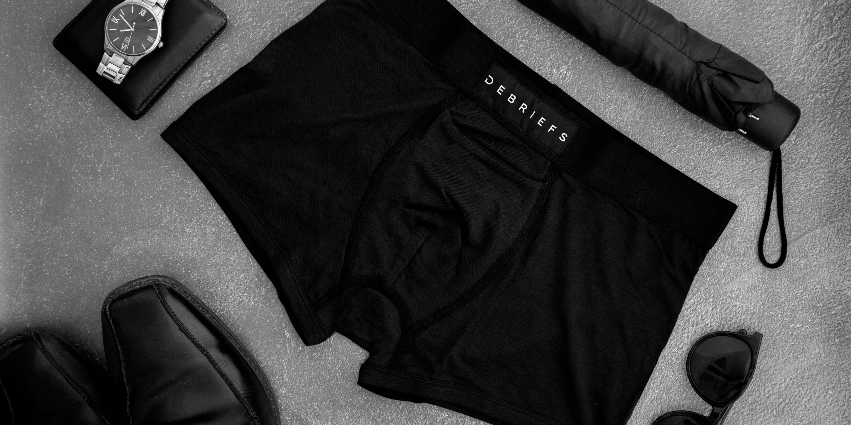 Pair of black Debriefs underwear laying on a table showcasing men's sustainable underwear
